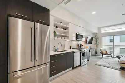 a large kitchen with a stainless steel refrigerator at 2880 Enchanting Moroccan Oasis in Denver