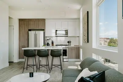 a kitchen and living room with a couch and a table at 2880 Denver Skyline Escape at Espadin in Denver