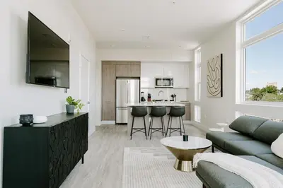 a living room and kitchen with a couch and a table at 2880 Denver Skyline Escape at Espadin in Denver