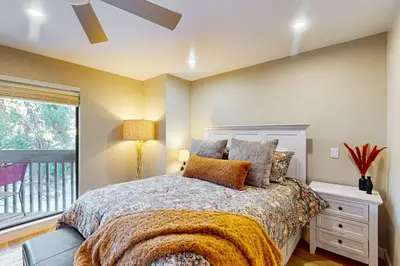 a bedroom with a bed and a window at SunSong Escape in Fraser