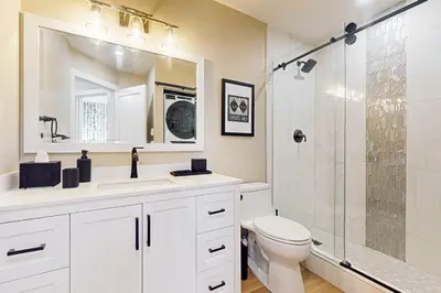 a bathroom with a toilet and a sink and a shower at SunSong Escape in Fraser