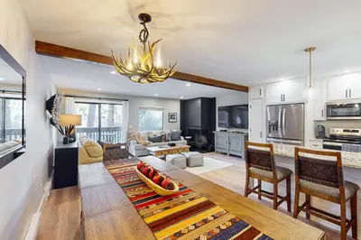 a kitchen and living room with a table and chairs at SunSong Escape in Fraser