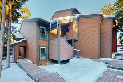 a house with snow on the ground in front of it at SunSong Escape in Fraser
