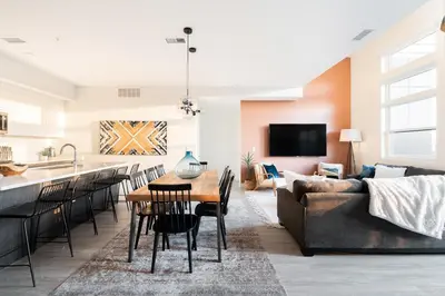 a kitchen and living room with a table and a couch at 2880 Bold & Elevated in Denver