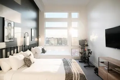 two beds in a bedroom with a large window at 2880 Bold & Elevated in Denver