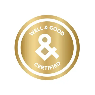 a gold button with a well and good certified symbol at 2880 Bold & Elevated in Denver