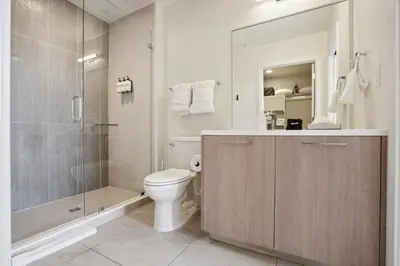 a bathroom with a toilet and a glass shower at 2880 Skyline Penthouse at Espadin in Denver