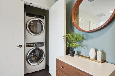a laundry room with a washer and dryer and a mirror at 2880 Skyline Penthouse at Espadin in Denver