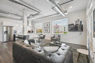 a living room with a couch and a table at RiNo Art Lofts in Denver