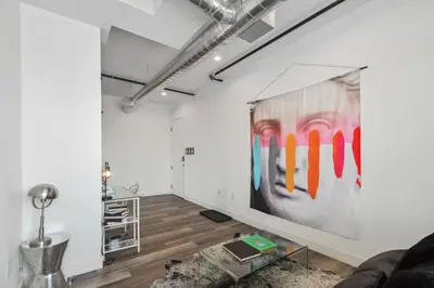 a living room with a large painting on the wall at RiNo Art Lofts in Denver