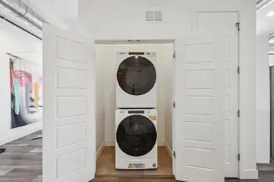 a washer and dryer in a room with white doors at RiNo Art Lofts in Denver
