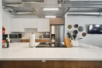 a kitchen with white cabinets and a counter top at RiNo Art Lofts in Denver