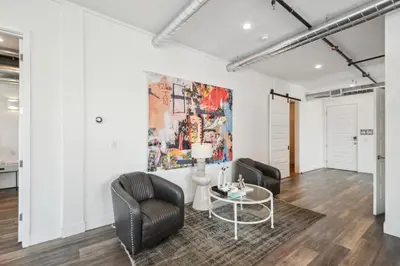 a living room with two chairs and a table at RiNo Art Lofts in Denver
