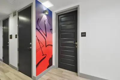 a hallway with two doors and a painting on the wall at 3198 Industrial Chic at RiNo Art Lofts in Denver