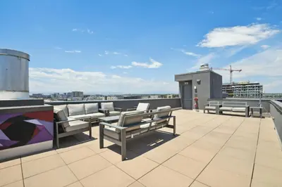 a balcony with benches on the roof of a building at 3198 Industrial Chic at RiNo Art Lofts in Denver