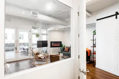 a living room with a mirror and a living room with a couch at 3198 Bohemian Hideaway at RiNo Art Lofts in Denver