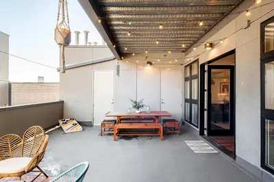 a patio with a wooden table and chairs at 3198 Bohemian Hideaway at RiNo Art Lofts in Denver