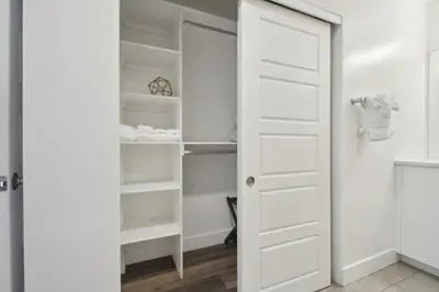 a closet with white doors and shelves at 3198 Urban Cowboy Escape at RiNo Art Lofts in Denver
