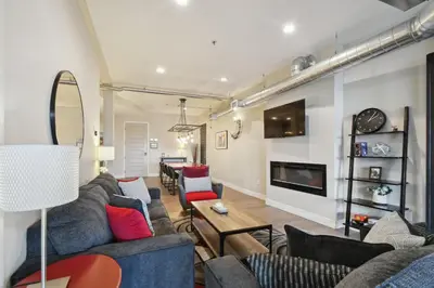 a living room with couches and a tv at 3198 Graffiti & Skyline at RiNo Art Lofts in Denver