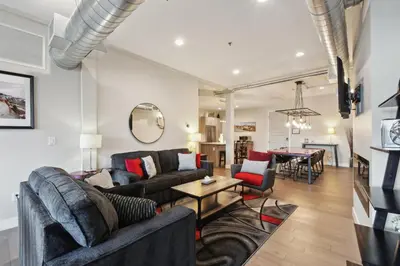 a living room with two couches and a table at 3198 Graffiti & Skyline at RiNo Art Lofts in Denver