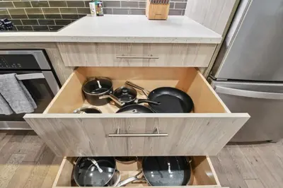 a kitchen drawer with pots and pans in it at 3198 Graffiti & Skyline at RiNo Art Lofts in Denver