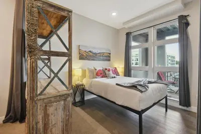 a bedroom with a bed and a large mirror at 3198 Graffiti & Skyline at RiNo Art Lofts in Denver