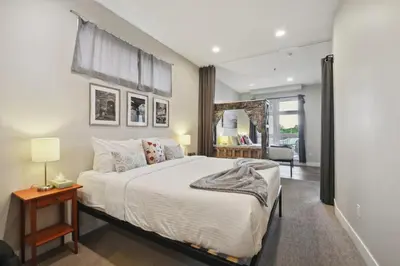 a bedroom with a large bed and a mirror at 3198 Graffiti & Skyline at RiNo Art Lofts in Denver
