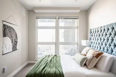 a bedroom with a large bed with a large window at 3198 Bright & Breezy at RiNo Art Lofts in Denver