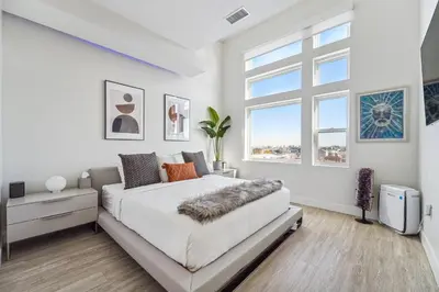 a white bedroom with a large bed and a window at 2880 The Penthouse at Espadin in Denver