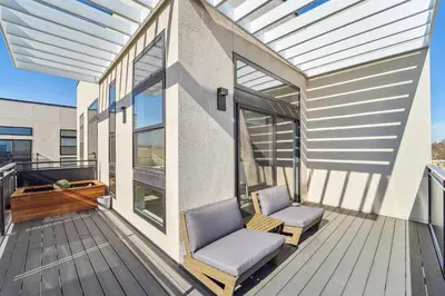 a balcony with two chairs and awning on a house at 2880 The Penthouse at Espadin in Denver
