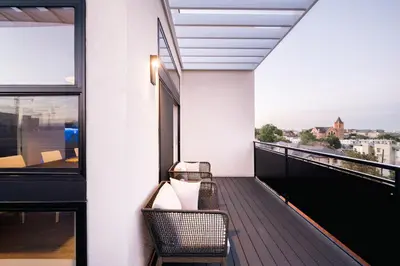 a balcony with two chairs and a view of the city at 2880 The Penthouse at Espadin in Denver