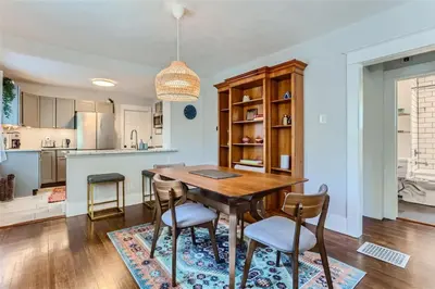 a kitchen and dining room with a wooden table and chairs at At S. Broadway An Artsy Bungalow Close to DU And Cherry Hills in Englewood