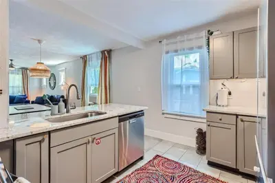 a kitchen with a sink and a counter top at At S. Broadway An Artsy Bungalow Close to DU And Cherry Hills in Englewood