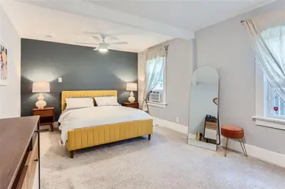 a bedroom with a yellow bed and a window at At S. Broadway An Artsy Bungalow Close to DU And Cherry Hills in Englewood