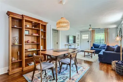 a living room with a table and chairs and a couch at At S. Broadway An Artsy Bungalow Close to DU And Cherry Hills in Englewood