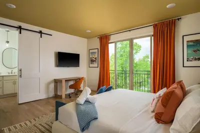 a bedroom with a large bed and a balcony at Accomodate 24 Guests with 2 Rooftops and 2 Hot Tubs and 2 Game Rooms in Denver