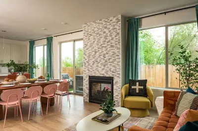 a living room with a table and a fireplace at Accomodate 24 Guests with 2 Rooftops and 2 Hot Tubs and 2 Game Rooms in Denver