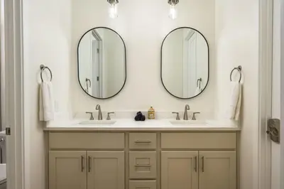 two mirrors above two sinks in a bathroom at Accomodate 24 Guests with 2 Rooftops and 2 Hot Tubs and 2 Game Rooms in Denver