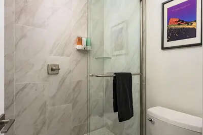 a shower with a glass door in a bathroom at Accomodate 24 Guests with 2 Rooftops and 2 Hot Tubs and 2 Game Rooms in Denver