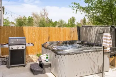a backyard with a hot tub and a grill at Hot Tub with Rooftop a Game Room and 5 Bathrooms in Denver