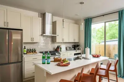 a kitchen with white cabinets and a counter with a sink at Hot Tub with Rooftop a Game Room and 5 Bathrooms in Denver