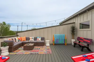 a patio with a couch and a bench on a deck at Hot Tub with Rooftop a Game Room and 5 Bathrooms in Denver