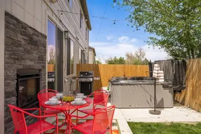 a patio with a table and chairs and a grill at Hot Tub with Rooftop a Game Room and 5 Bathrooms in Denver