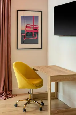 a desk with a yellow chair and a television at Hot Tub with Rooftop a Game Room and 5 Bathrooms in Denver