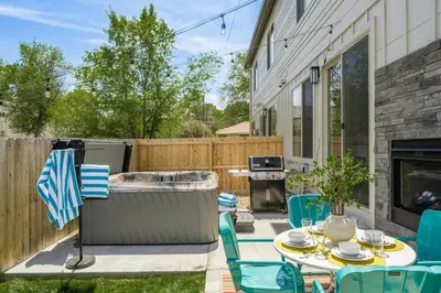 a backyard with a hot tub and a table and chairs at Hot Tub With Rooftop A Game Room And5 Bathrooms in Denver