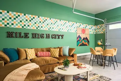 a living room with a couch and a table at Hot Tub With Rooftop A Game Room And5 Bathrooms in Denver
