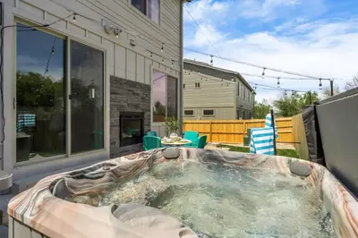 a hot tub in the backyard of a house at Hot Tub With Rooftop A Game Room And5 Bathrooms in Denver