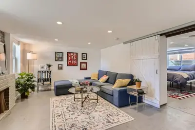 a living room with a blue couch and a table at A Pet Friendly And Remodeled I Near RiNo Where Sleeps 7 in Denver