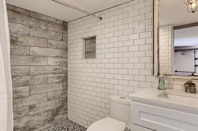 a white bathroom with a toilet and a sink at A Pet Friendly And Remodeled I Near RiNo Where Sleeps 7 in Denver