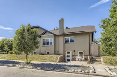 a large house with a driveway and trees at A Pet Friendly And Remodeled I Near RiNo Where Sleeps 7 in Denver